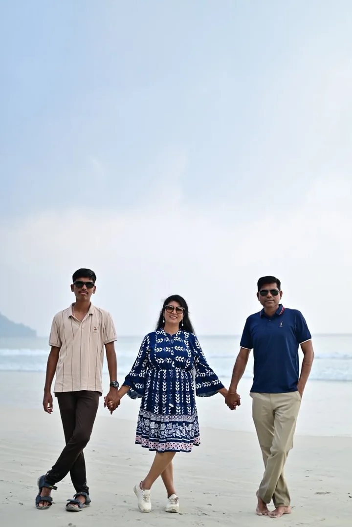 A family group walking hand in hand along an Andaman beach