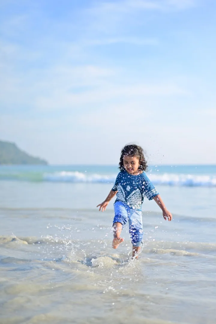 A child enjoying the waves during an Andaman family holiday