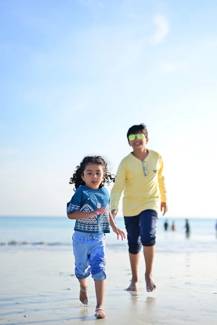 Children running along the shore during an Andaman holiday
