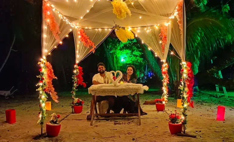 Guests enjoying a candlelit dinner beside an Andaman beach