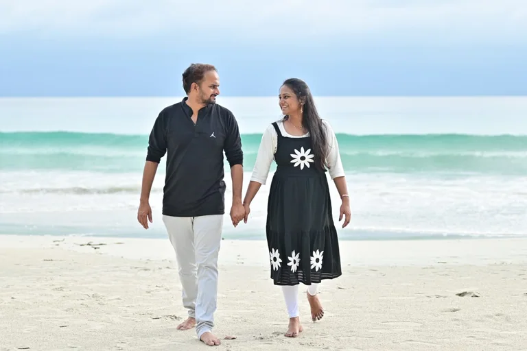 A couple walking hand in hand along the Andaman shoreline