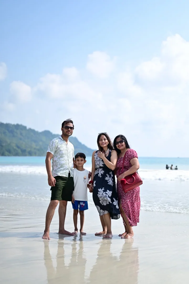 A family group sharing a joyful moment beside the sea